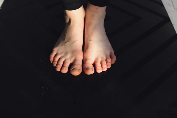 Close-up on feet showing balance and stability during an exercise.